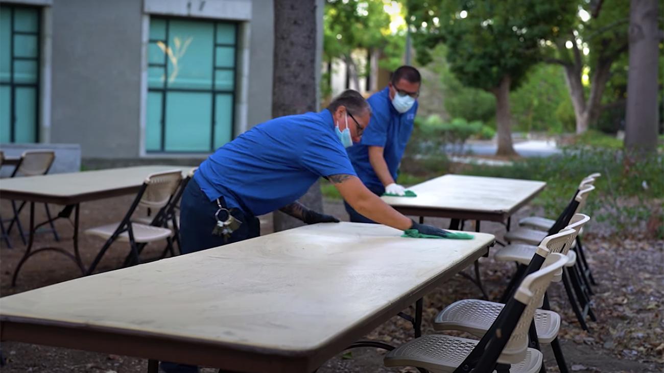 Staff cleaning tables