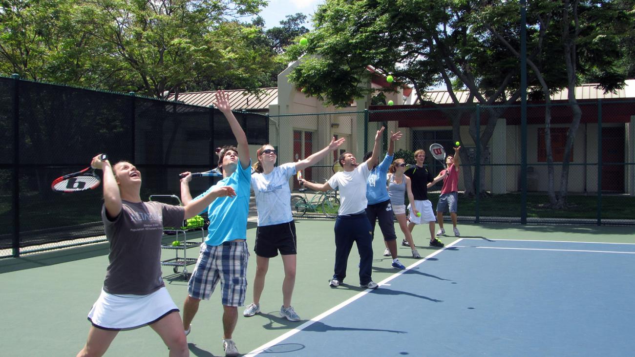 Beginning Tennis class practices their serves